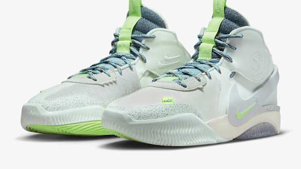 Side view of green and blue Nike shoes.